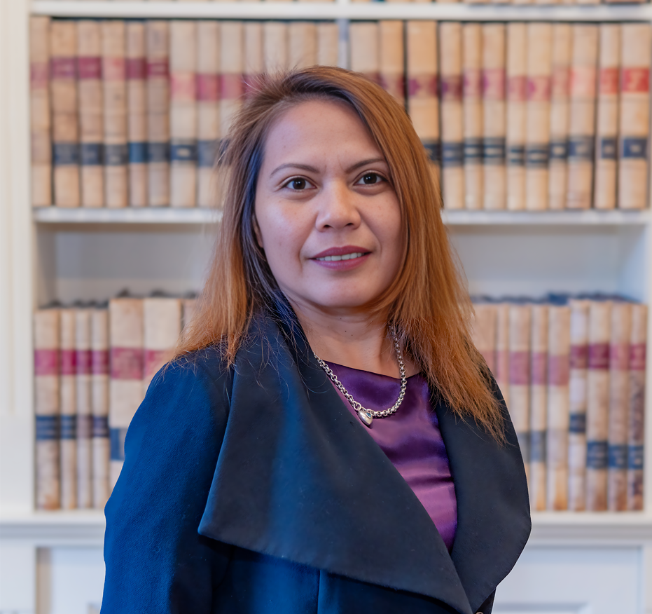 Woman in coat, purple top, books